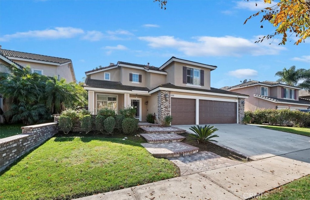 1040 Nighthawk Circle Corona, CA 92881 - Photo 4 of 39 a front view of a house with a yard