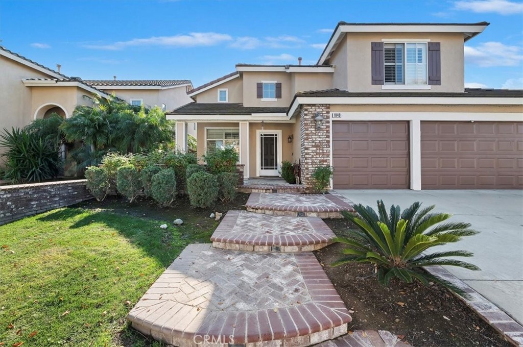 1040 Nighthawk Circle Corona, CA 92881 - Photo 6 of 39 a front view of a house with garden