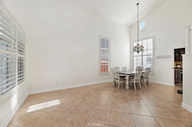 a dining room with furniture and a window