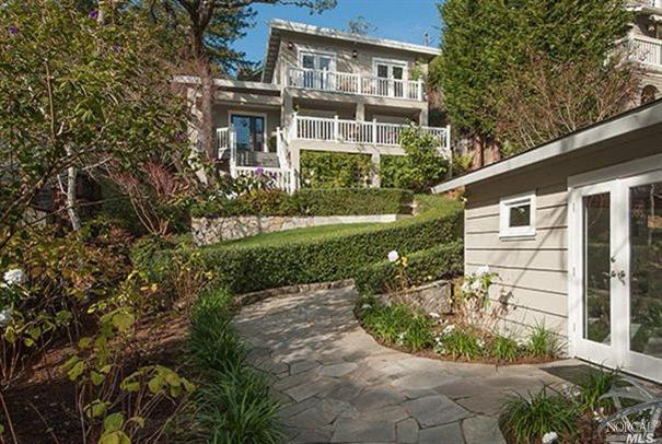 a front view of a house with garden
