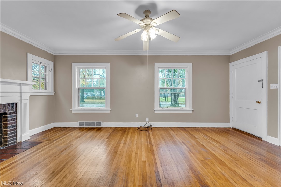 3609 Strandhill Road Shaker Heights, OH 44122 - Photo 35 of 47 Unfurnished living room with light hardwood / wood-style floors, a fireplace, ceiling fan, and ornamental molding