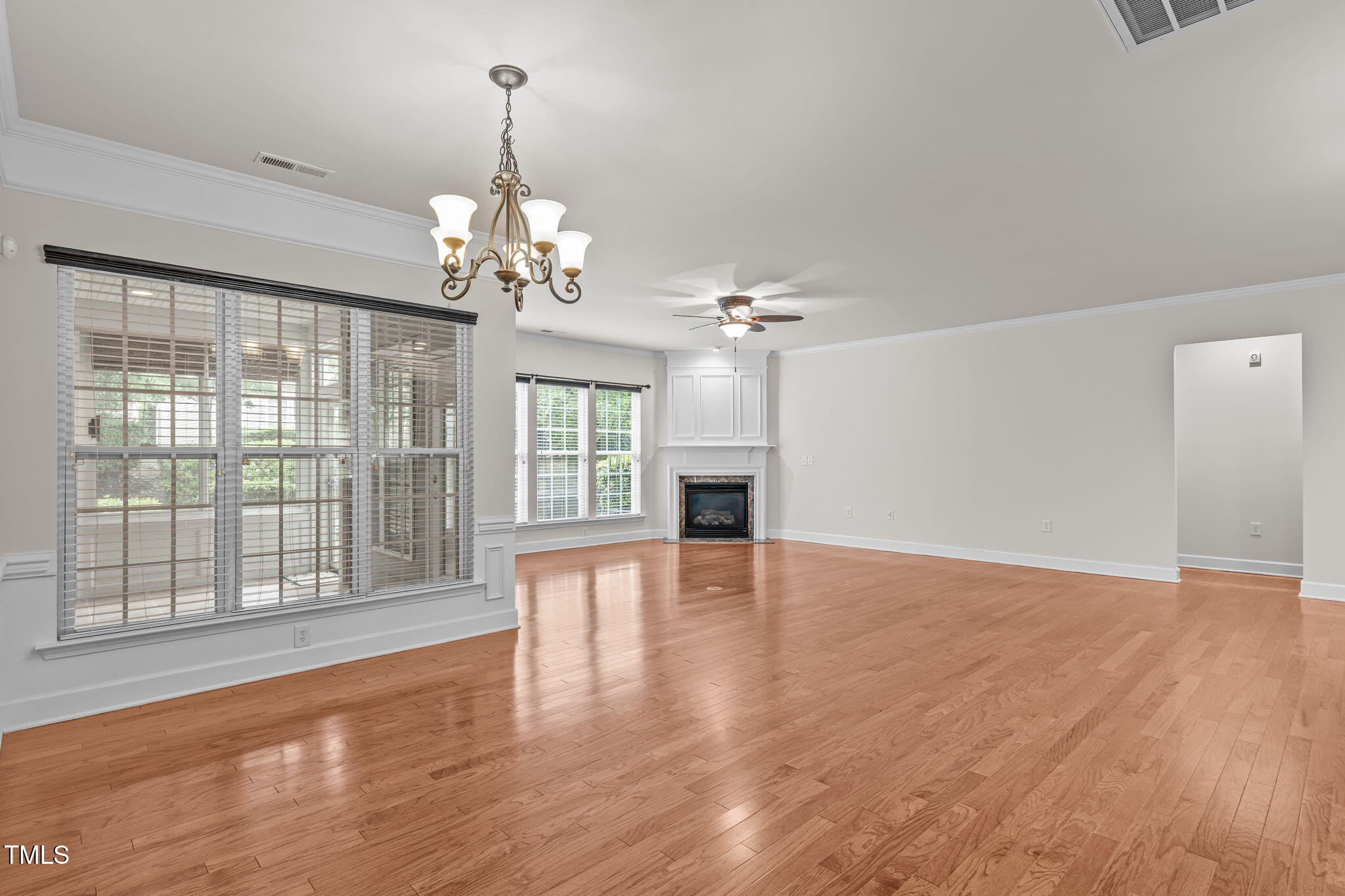 208 Beckingham Loop Cary, NC 27519 - Photo 13 of 47 a view of an empty room with wooden floor and a window