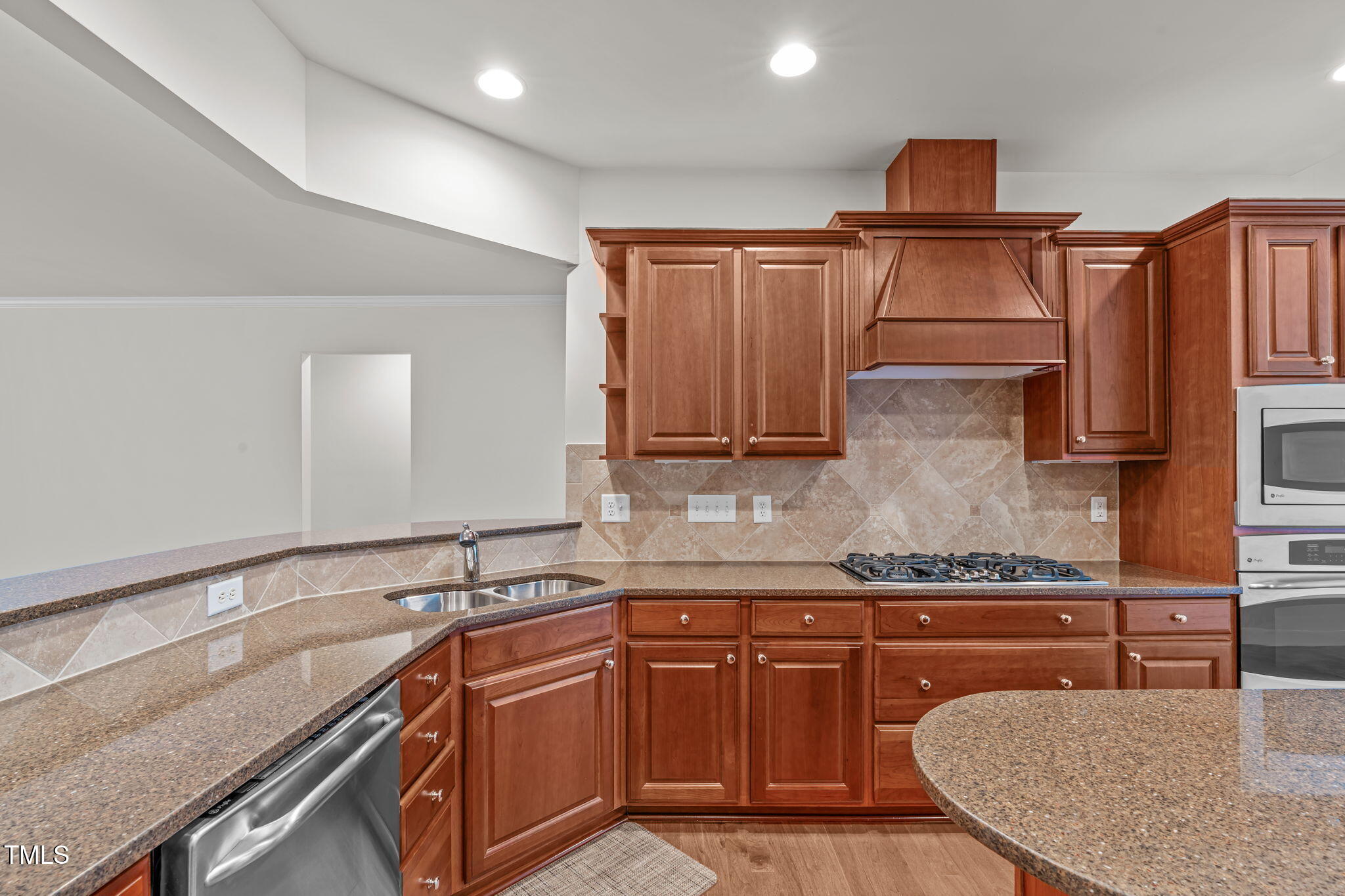 208 Beckingham Loop Cary, NC 27519 - Photo 16 of 47 a kitchen with granite countertop stainless steel appliances and wooden cabinets