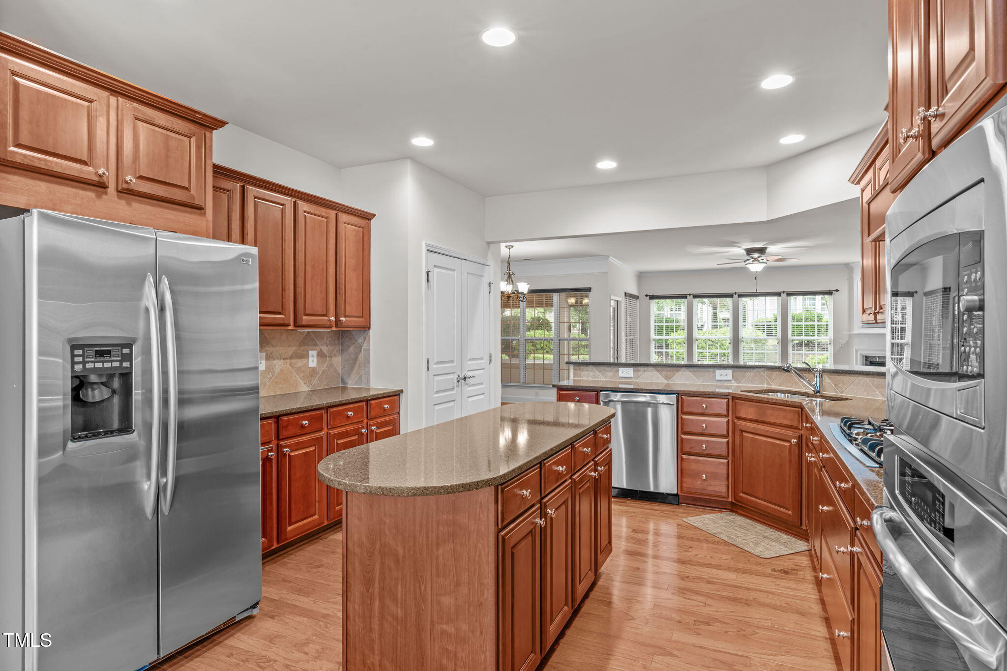 208 Beckingham Loop Cary, NC 27519 - Photo 18 of 47 a kitchen with stainless steel appliances granite countertop a refrigerator a sink a stove and oven