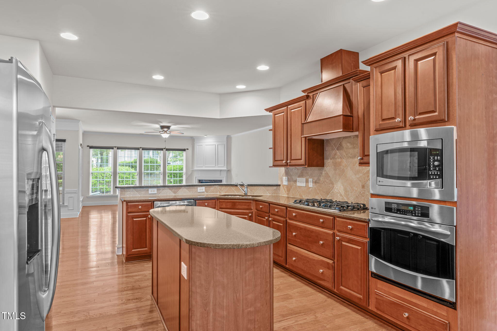 208 Beckingham Loop Cary, NC 27519 - Photo 19 of 47 a kitchen with stainless steel appliances granite countertop a stove a sink and a refrigerator
