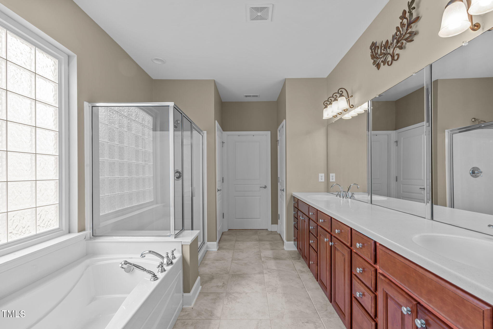 208 Beckingham Loop Cary, NC 27519 - Photo 26 of 47 a spacious bathroom with sinks mirror and a bathtub
