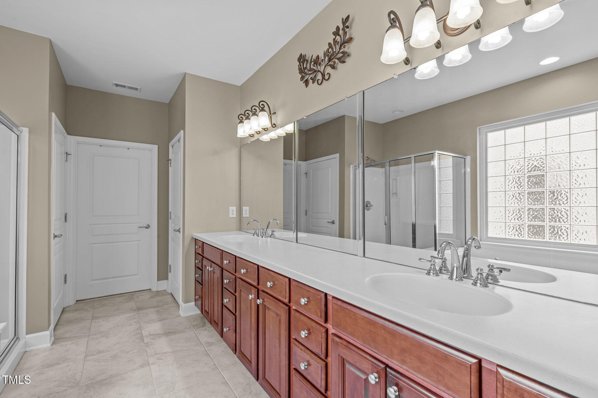 208 Beckingham Loop Cary, NC 27519 - Photo 27 of 47 a bathroom with a double vanity sink and a mirror