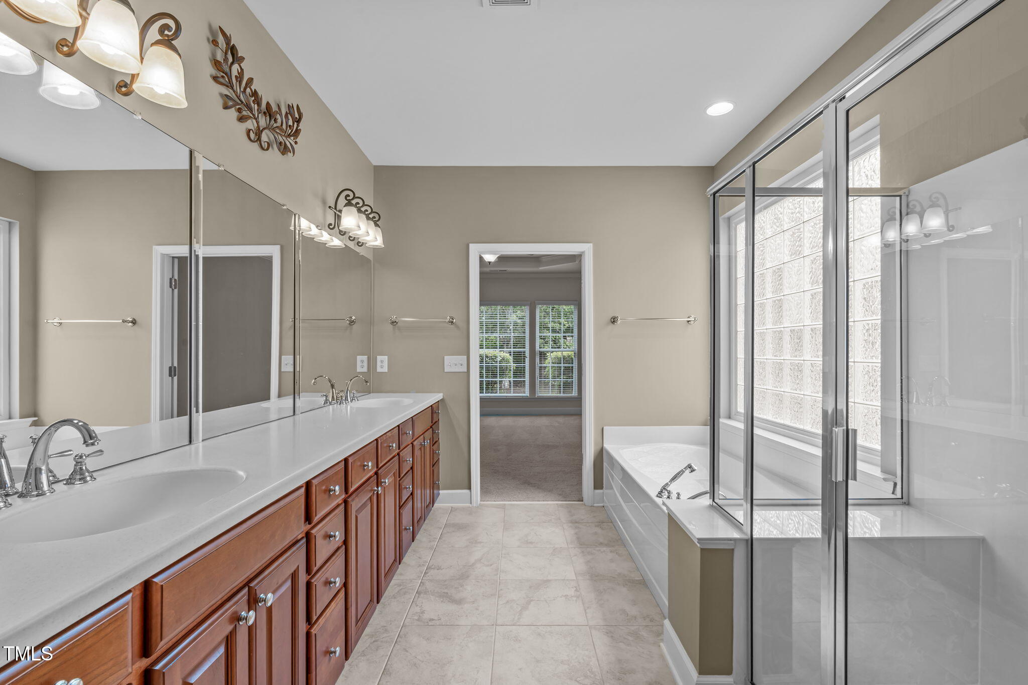 208 Beckingham Loop Cary, NC 27519 - Photo 29 of 47 a bathroom with a double vanity sink and mirror with shower