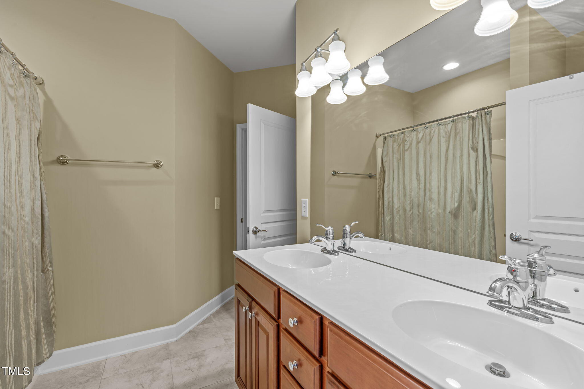 208 Beckingham Loop Cary, NC 27519 - Photo 35 of 47 a bathroom with a sink and a mirror