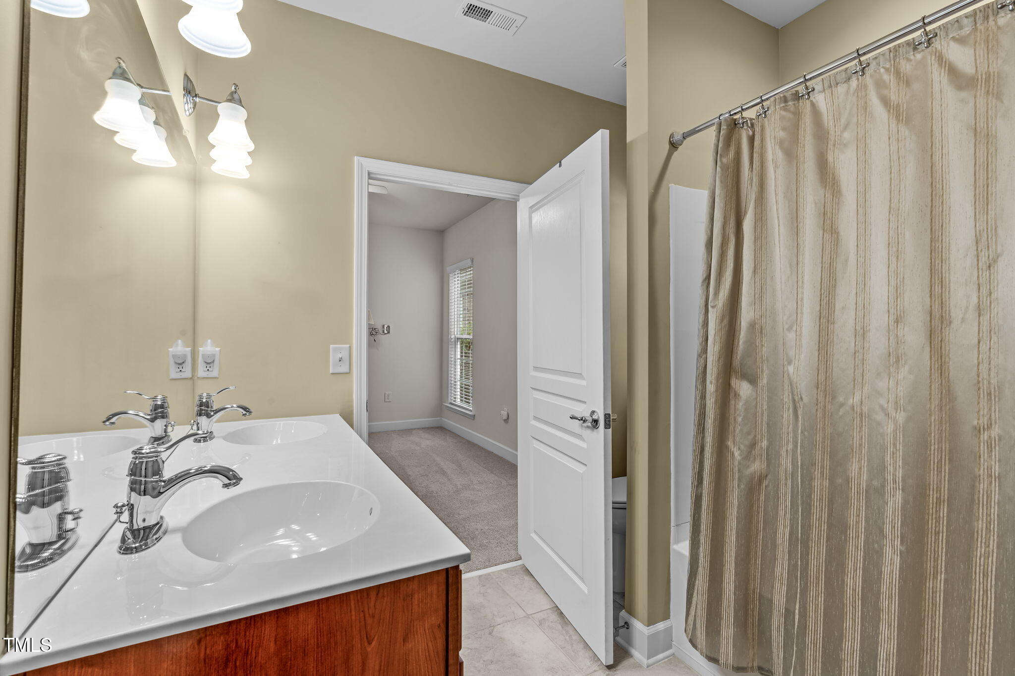 208 Beckingham Loop Cary, NC 27519 - Photo 36 of 47 a bathroom with a sink a mirror and a shower
