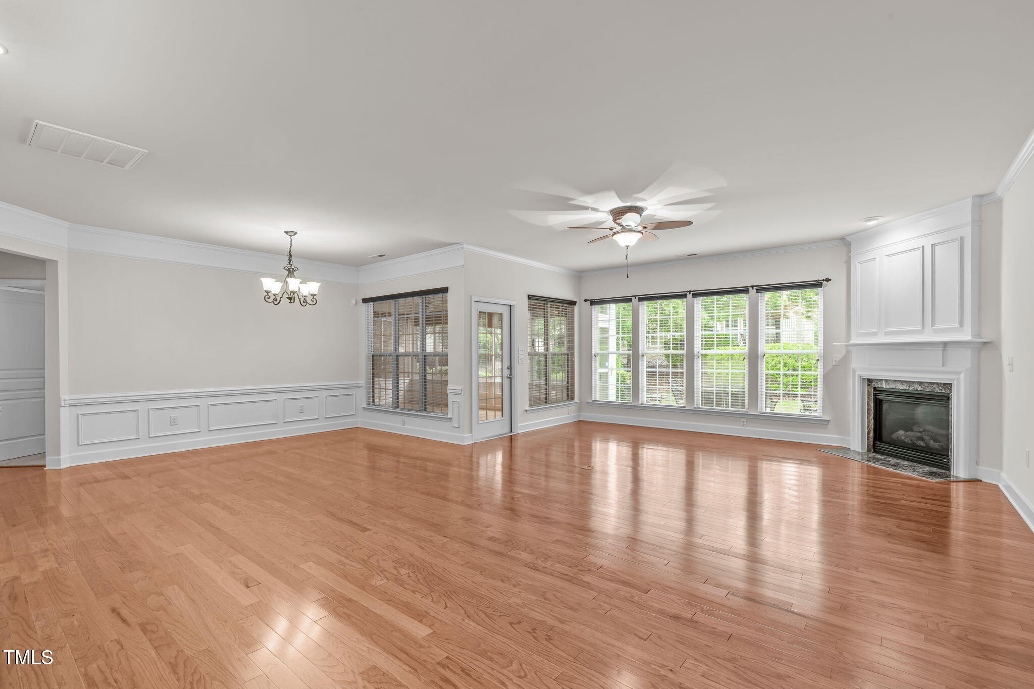208 Beckingham Loop Cary, NC 27519 - Photo 4 of 47 a view of an empty room with wooden floor and a fireplace