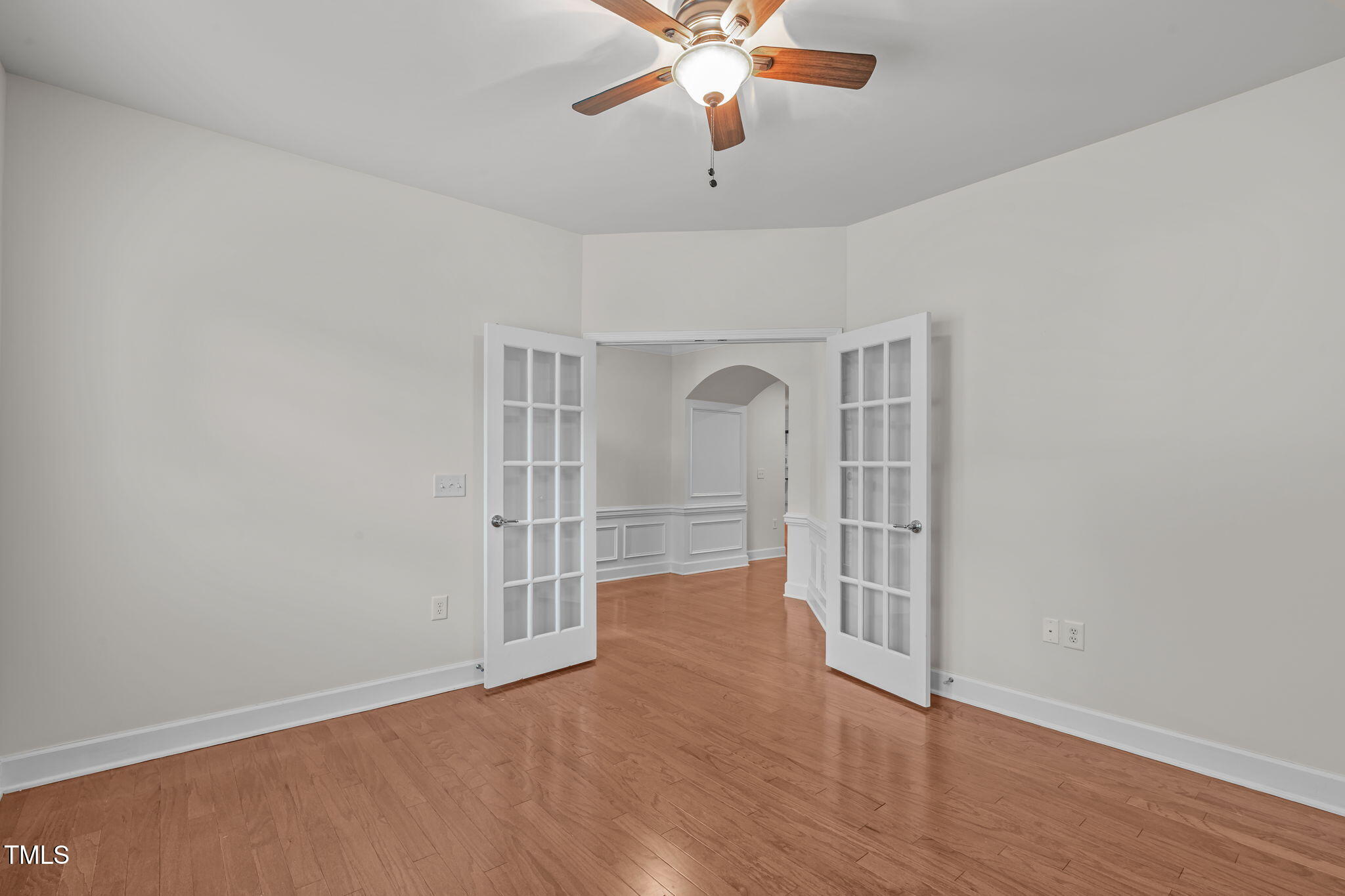 208 Beckingham Loop Cary, NC 27519 - Photo 7 of 47 an empty room with wooden floor chandelier fan and windows
