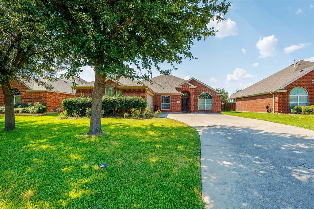 View of front of house featuring a garage, brick siding, a front lawn, driveway, and a shingled roof