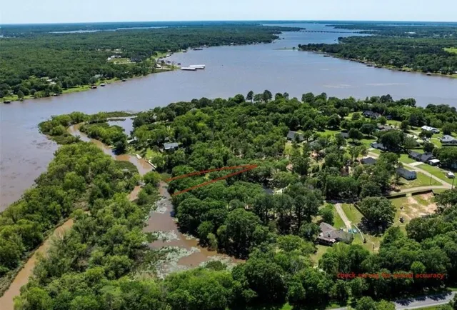 an aerial view of a houses with yard and green space