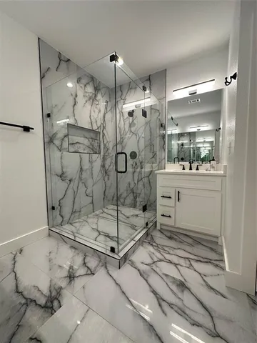 a bathroom with a shower and a sink