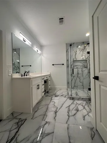 a bathroom with a sink mirror toilet and shower