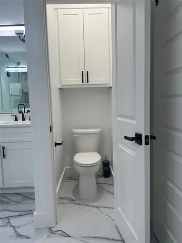 a bathroom with a toilet and a sink