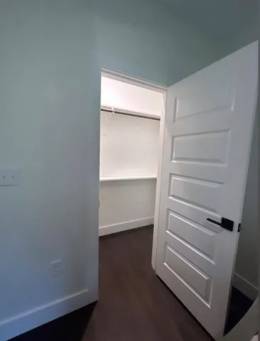 a view of walk in closet with empty racks