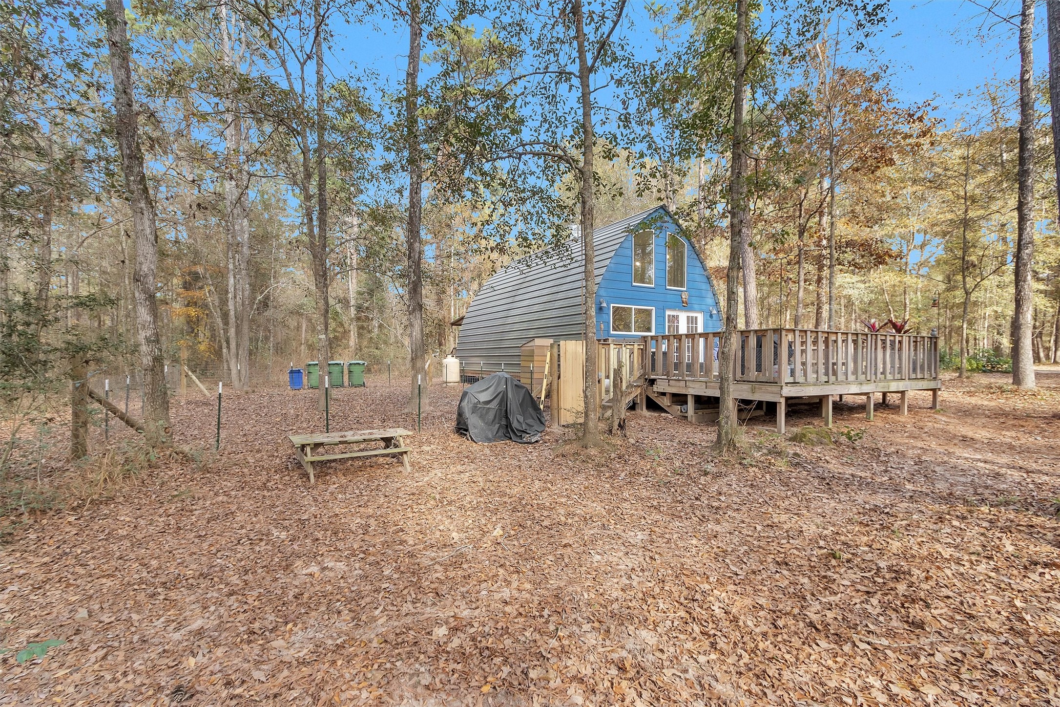 215 Fm 2929 Road Huntsville, TX 77340 - Photo 15 of 50 a backyard of a house with barbeque oven table and chairs