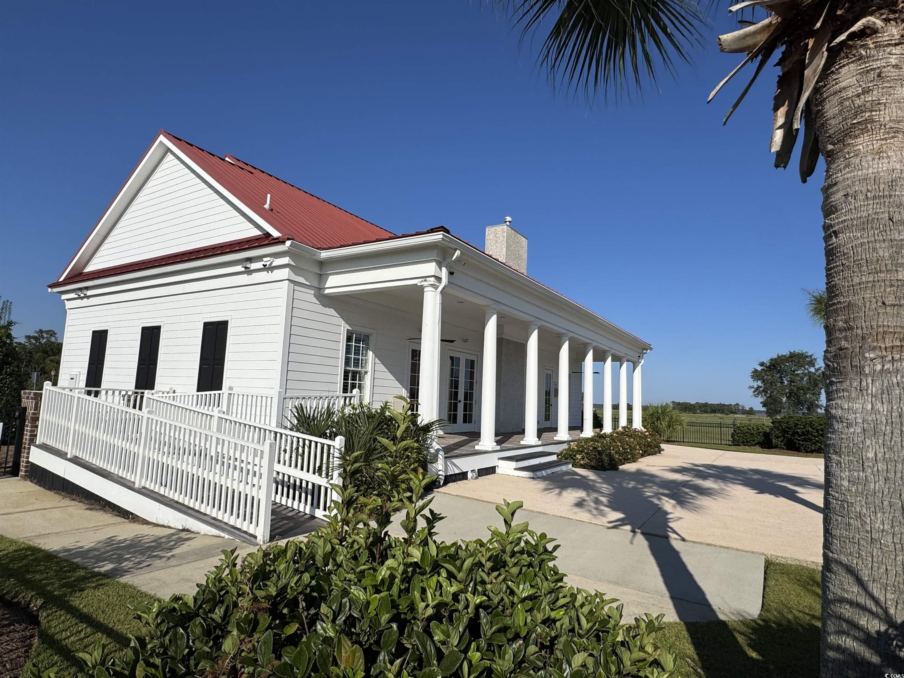 Lot 95 Cravens Street Georgetown, SC 29440 - Photo 14 of 17 Rear view of property featuring a porch, a chimney