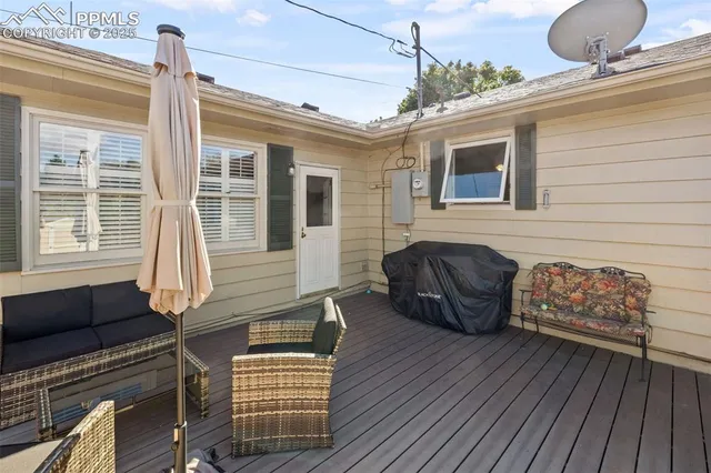 a front view of a house with wooden floor and outdoor seating