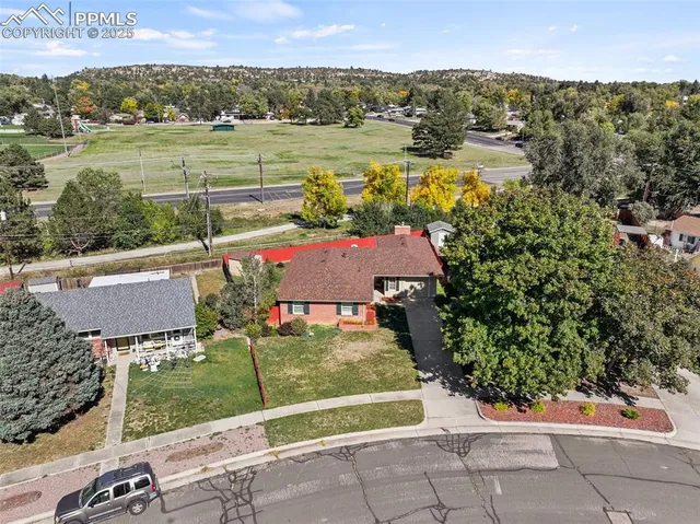 an aerial view of a house with a yard and lake view