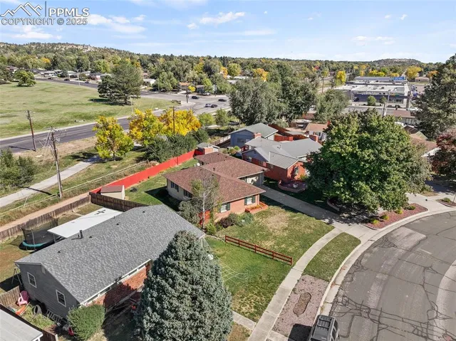 an aerial view of residential houses with outdoor space and ocean view