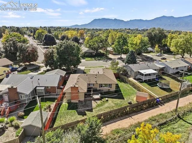 an aerial view of residential houses with outdoor space