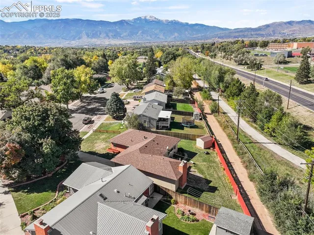 an aerial view of residential houses with outdoor space and river