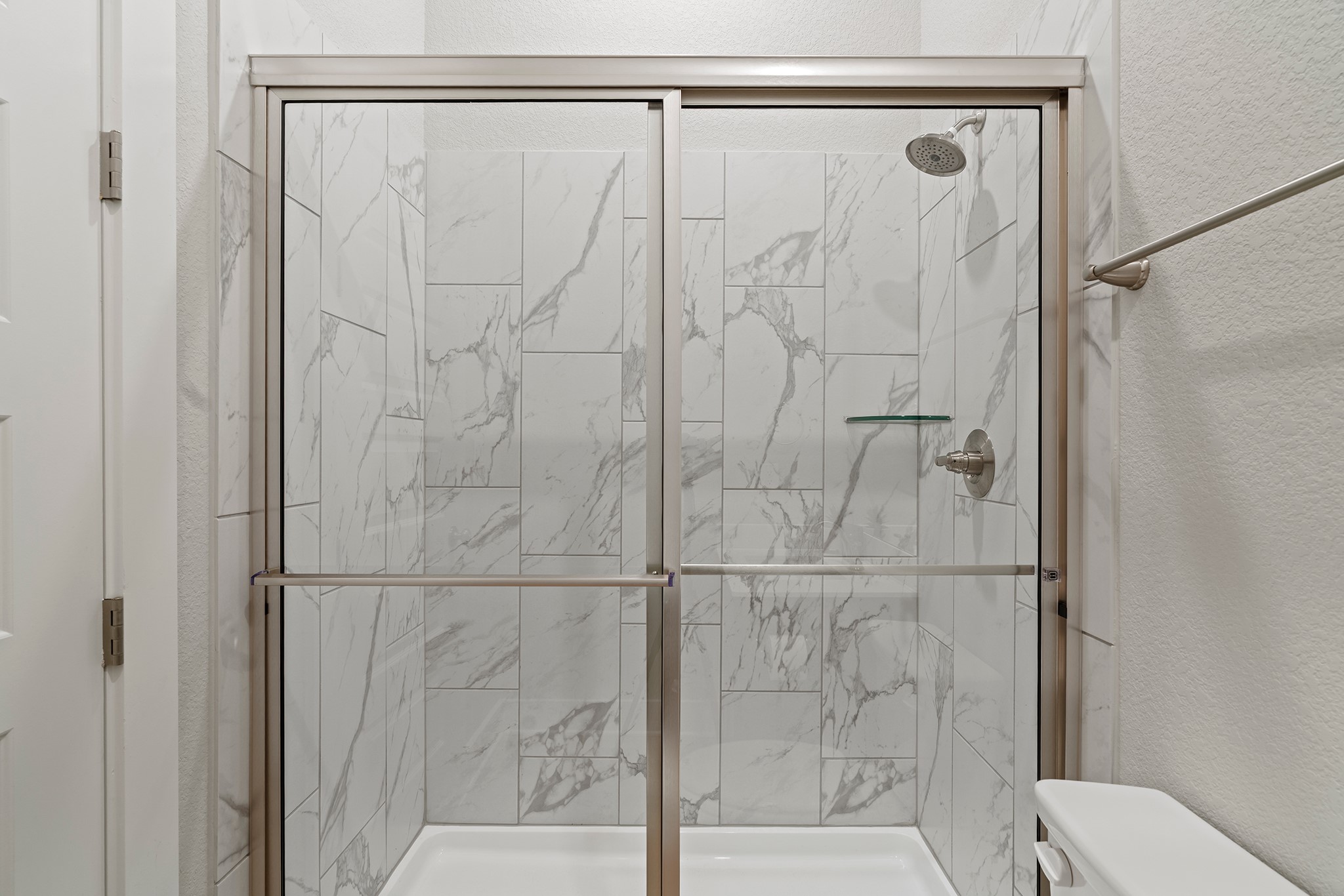 2112 Tobiano Trace Georgetown, TX 78633 - Photo 25 of 40 Full bath with a textured wall and a marble finish shower