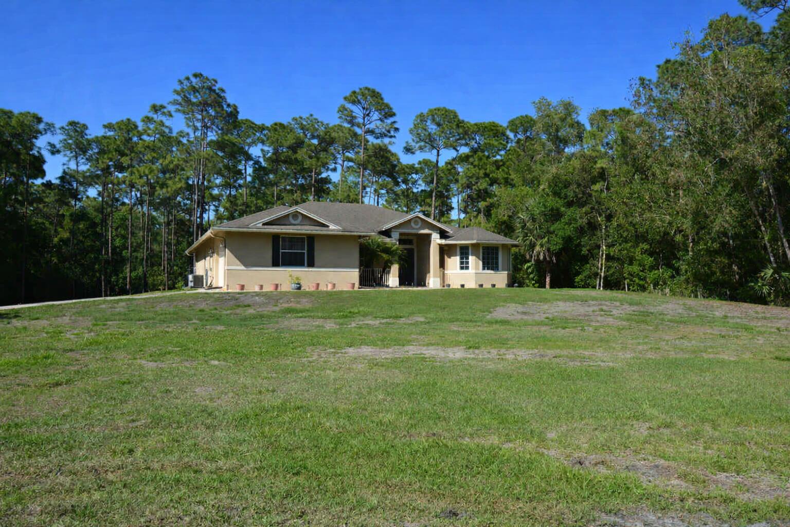 11923 154th Road North Jupiter Farms, FL 33478 - Photo 1 of 6 a front view of a house with a yard