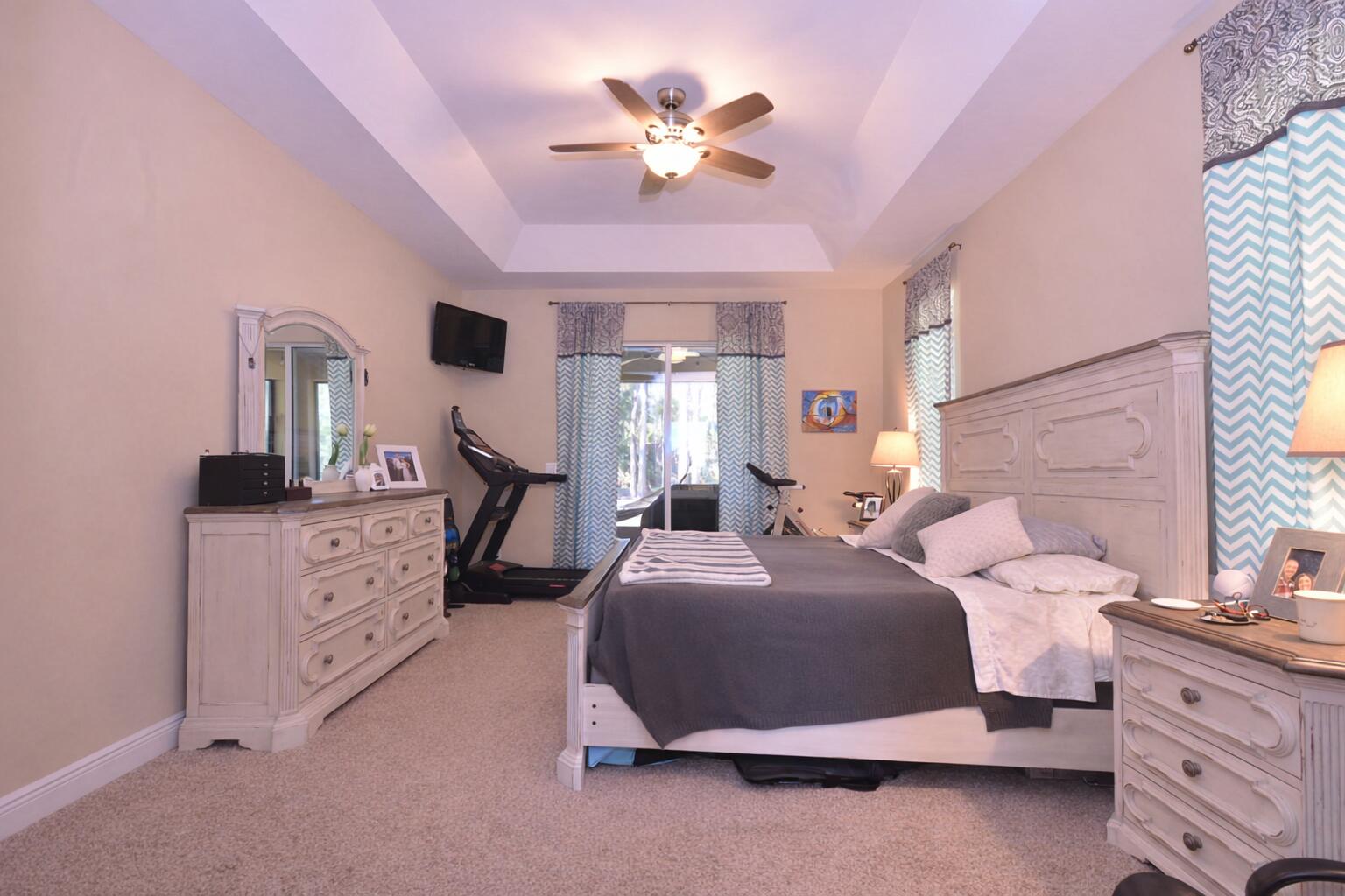 11923 154th Road North Jupiter Farms, FL 33478 - Photo 3 of 6 a bedroom with a bed a chandelier and dresser