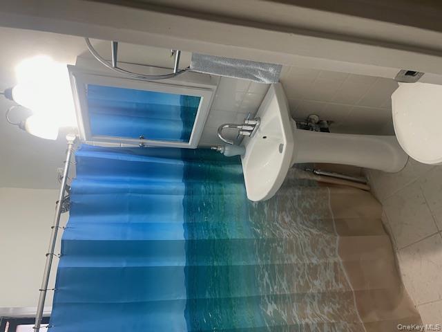 2165 Matthews Avenue, Unit 4F Bronx, NY 10462 - Photo 3 of 7 a bathroom with a sink a toilet and shower