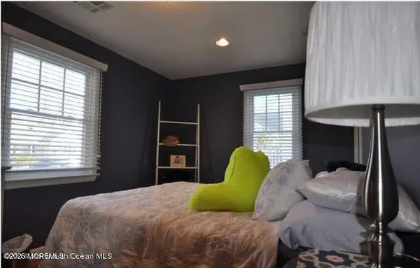 a bedroom with a bed dresser and a window