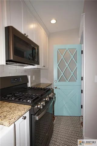 a kitchen with a stove and a microwave
