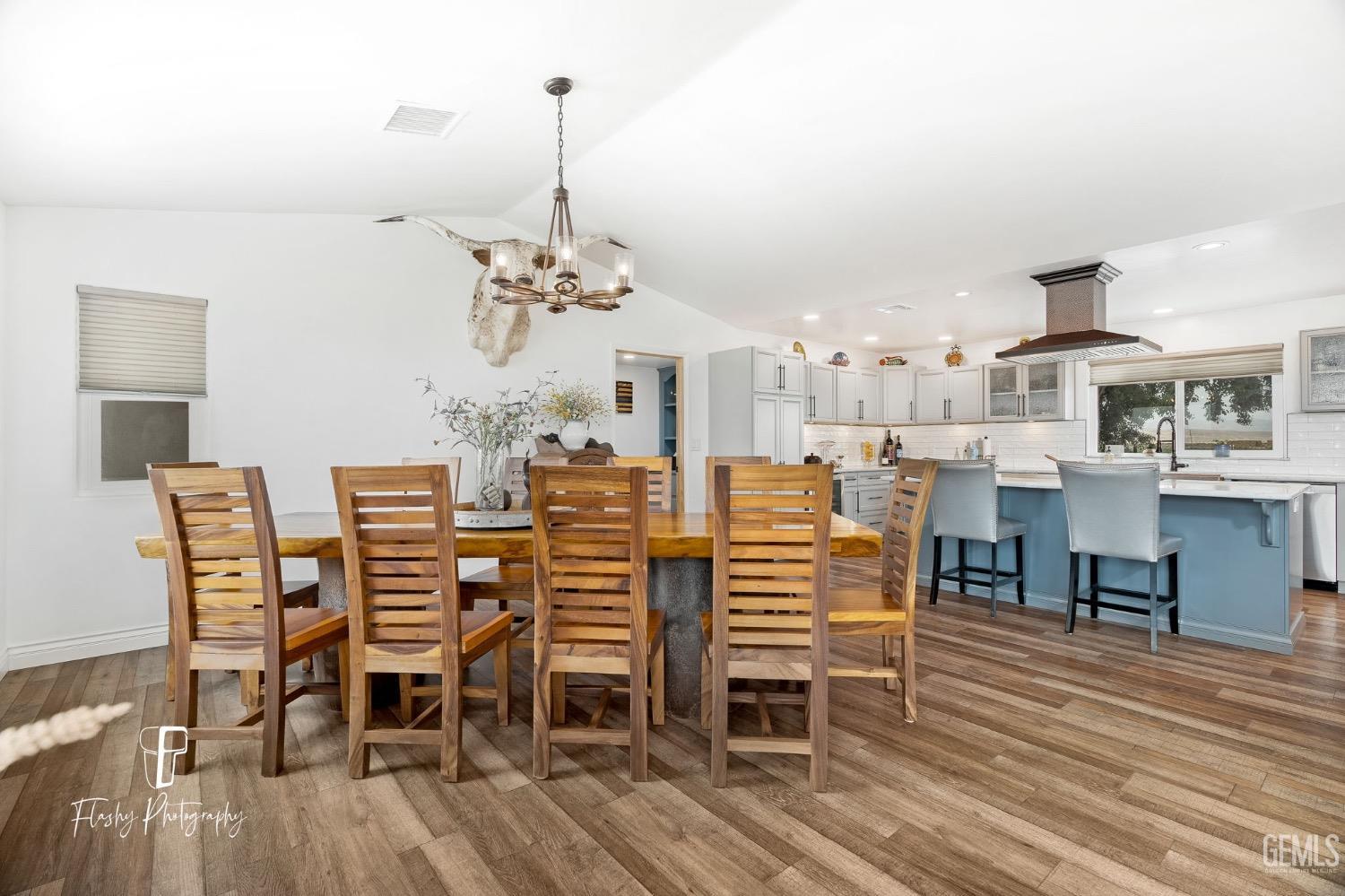 Undisclosed Address Buttonwillow, CA 93206 - Photo 11 of 65 a dining room with furniture a chandelier and wooden floor