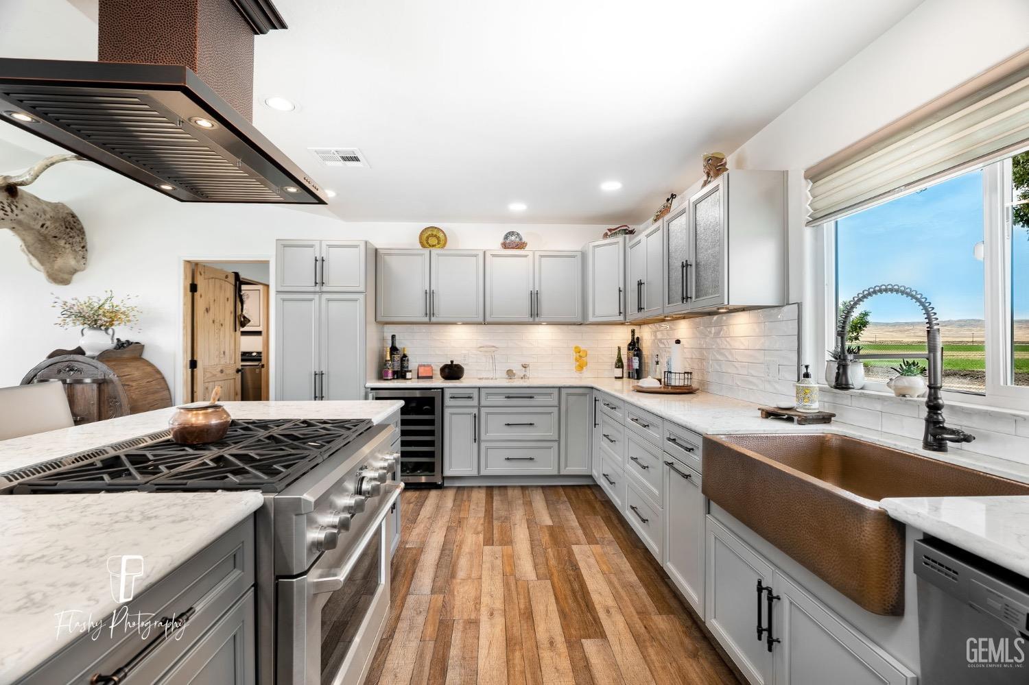 Undisclosed Address Buttonwillow, CA 93206 - Photo 14 of 65 a kitchen with a stove sink and cabinets