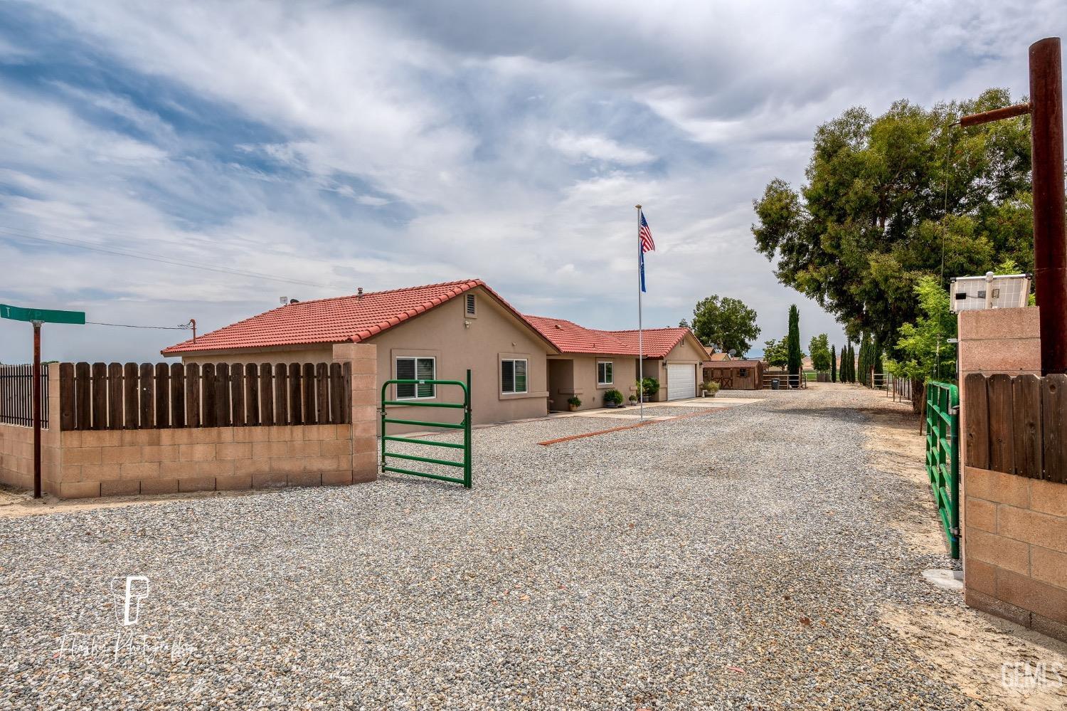 Undisclosed Address Buttonwillow, CA 93206 - Photo 2 of 65 a view of a house with a yard and wooden fence