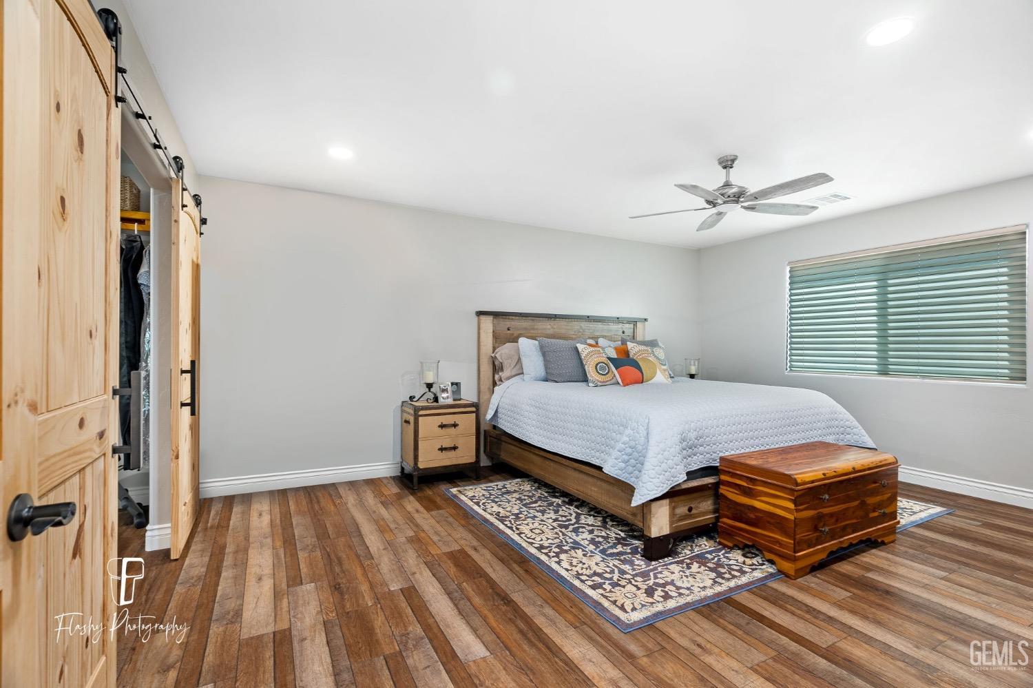 Undisclosed Address Buttonwillow, CA 93206 - Photo 21 of 65 a bedroom with a bed and wooden floor