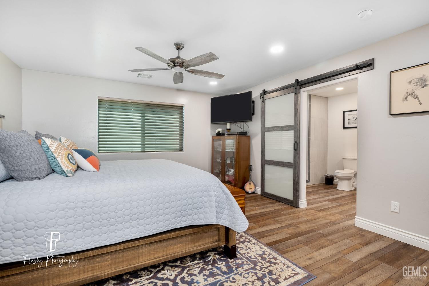 Undisclosed Address Buttonwillow, CA 93206 - Photo 22 of 65 a bedroom with a bed and a flat screen tv