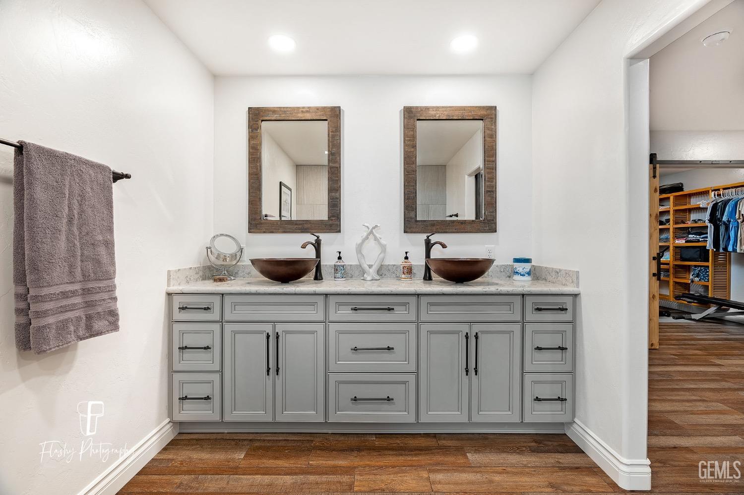 Undisclosed Address Buttonwillow, CA 93206 - Photo 26 of 65 a bathroom with double vanity sink a two mirror a window and a glass door