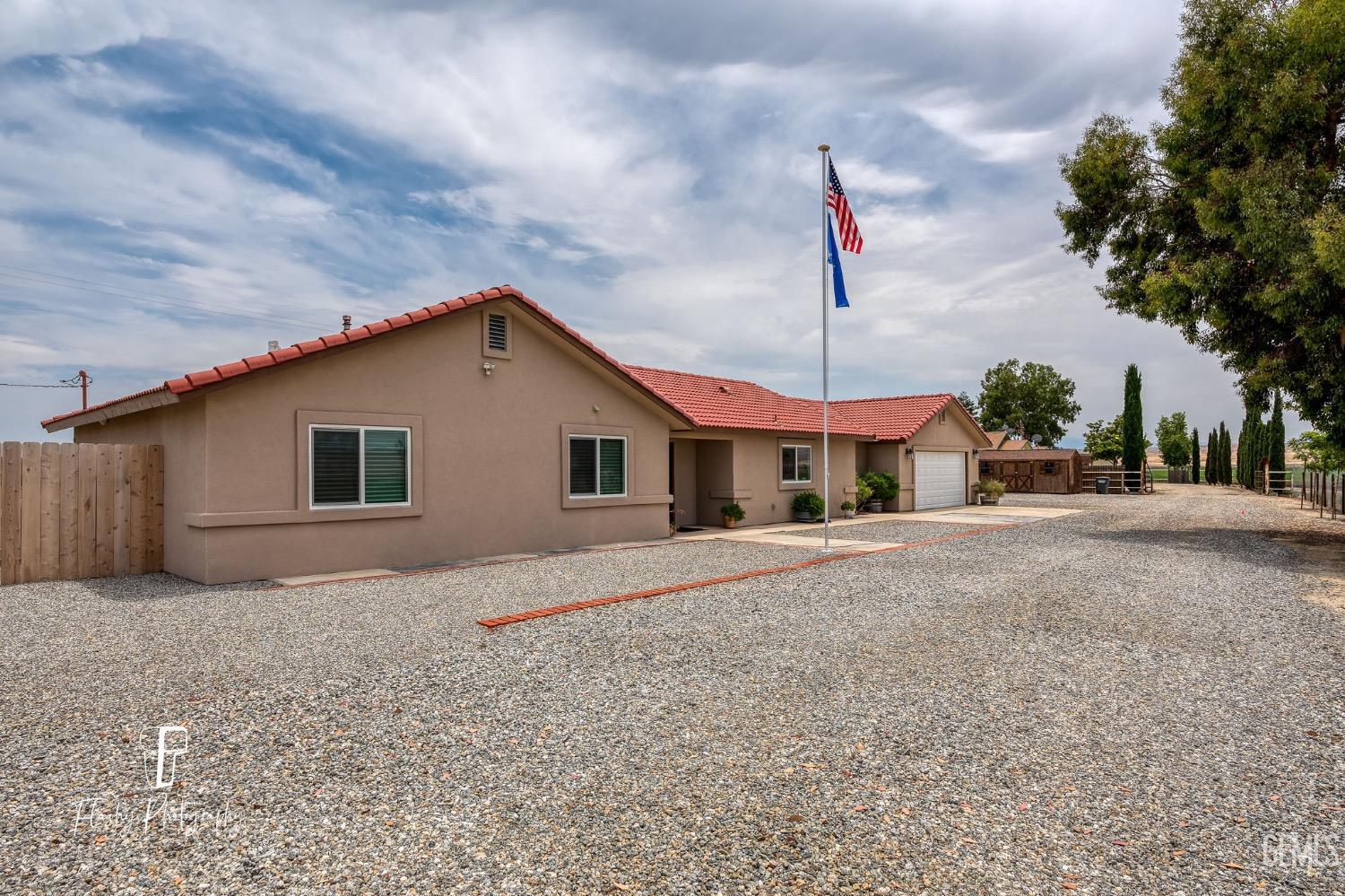 Undisclosed Address Buttonwillow, CA 93206 - Photo 3 of 65 a front view of a house with a yard
