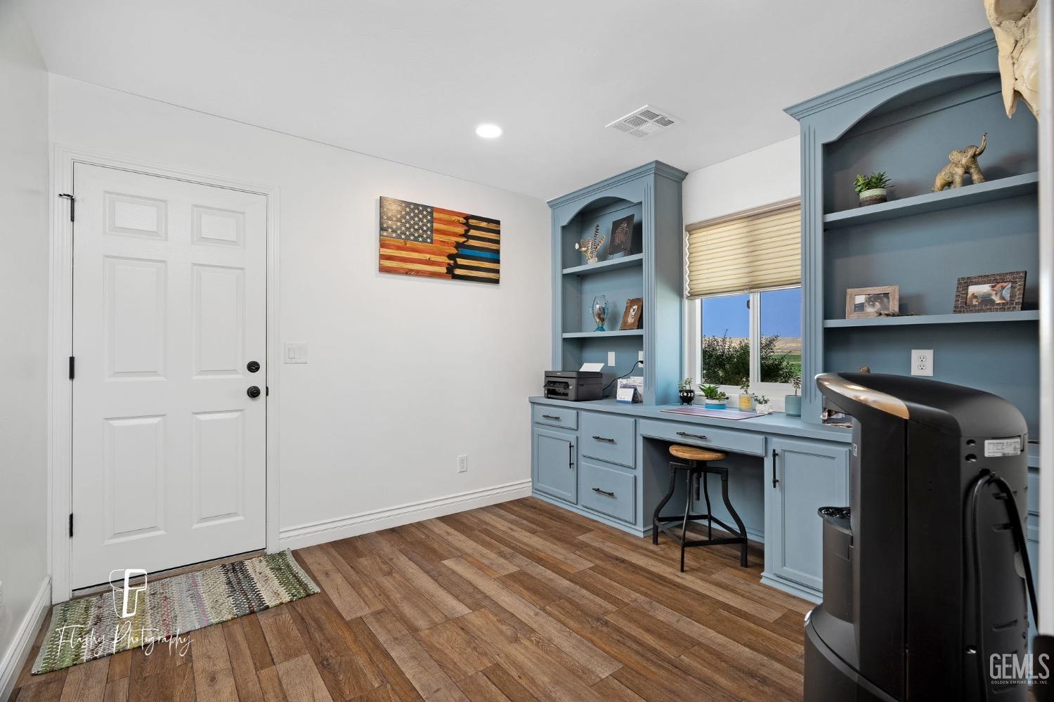 Undisclosed Address Buttonwillow, CA 93206 - Photo 31 of 65 a view of a workspace with furniture and wooden floor