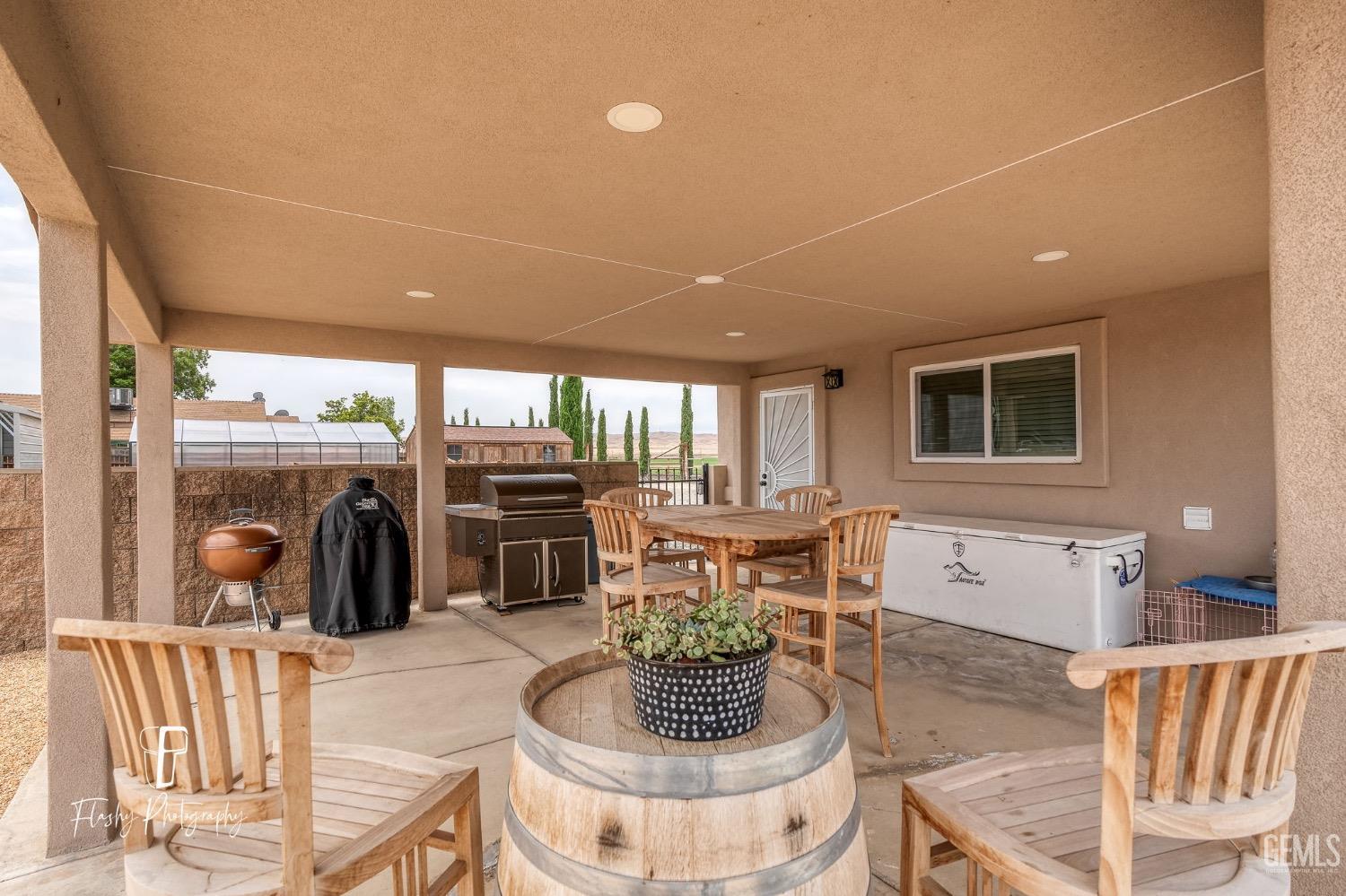 Undisclosed Address Buttonwillow, CA 93206 - Photo 42 of 65 a living room with furniture a fireplace and a floor to ceiling window
