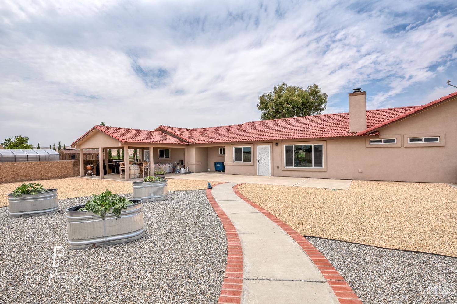 Undisclosed Address Buttonwillow, CA 93206 - Photo 43 of 65 a front view of a house with garden