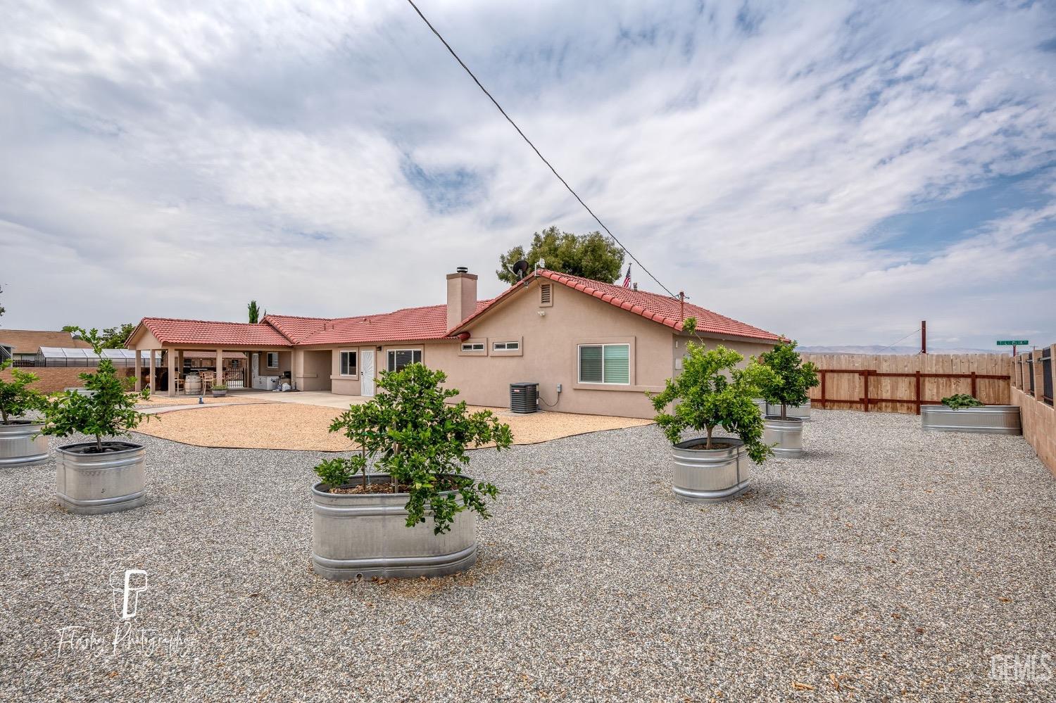 Undisclosed Address Buttonwillow, CA 93206 - Photo 44 of 65 a front view of a house with garden