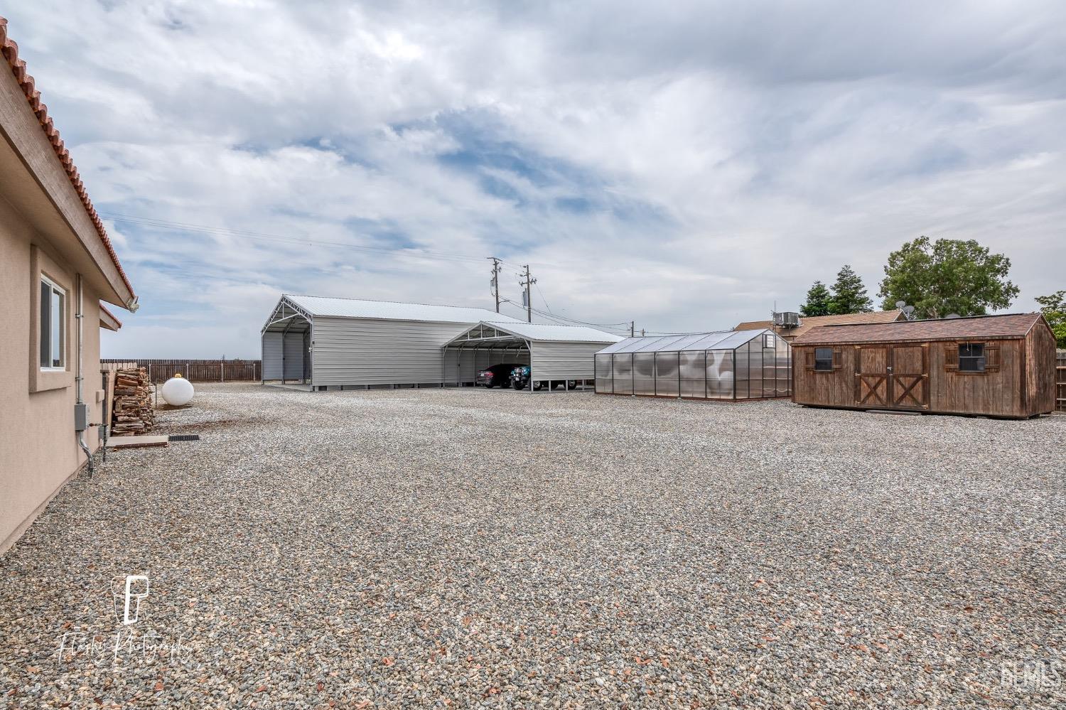 Undisclosed Address Buttonwillow, CA 93206 - Photo 46 of 65 a front view of a house with a yard and car parked