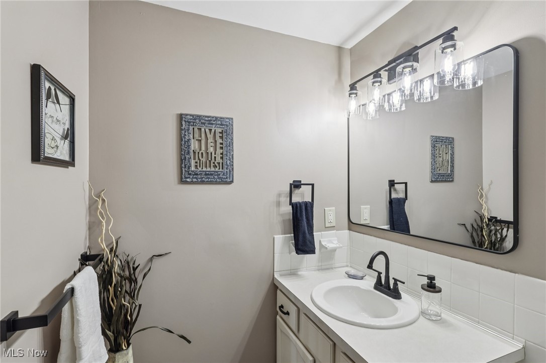 751 Bacon Road Painesville, OH 44077 - Photo 33 of 50 Bathroom featuring vanity and backsplash