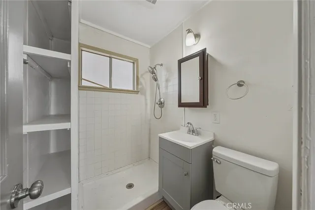 a bathroom with a toilet sink and shower