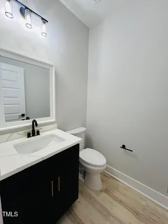 a bathroom with a sink toilet a mirror and vanity